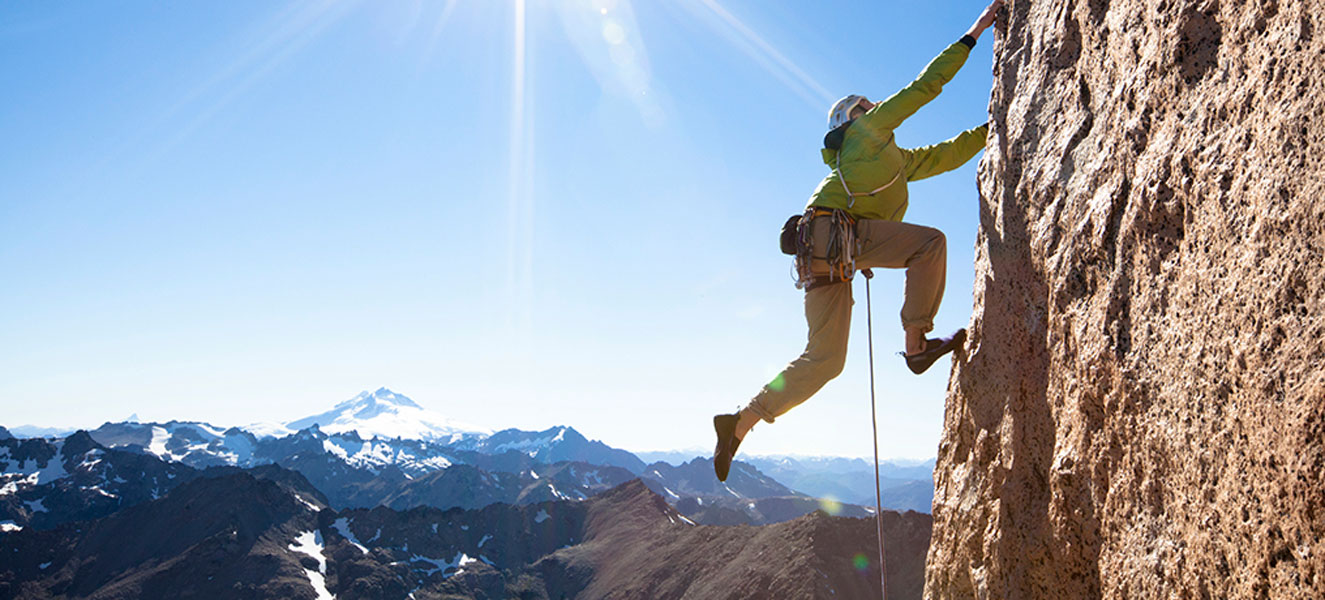 A rock climber on a vertical rock face
